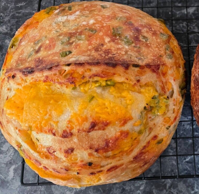 A Jalapeño Cheddar sourdough loaf with melted cheddar and green jalapeño